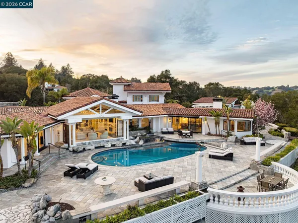 an aerial view of a house with swimming pool garden and patio