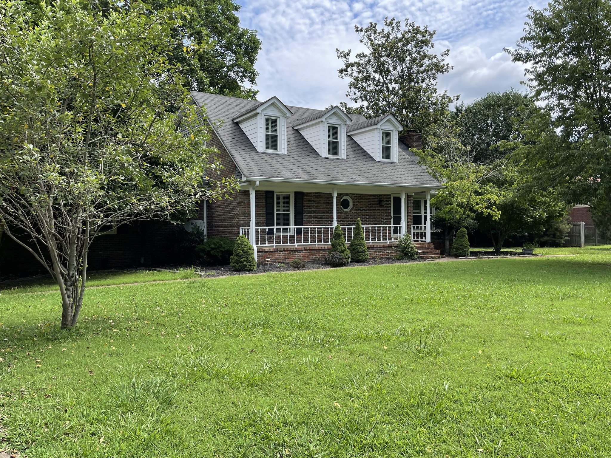 a front view of a house with garden