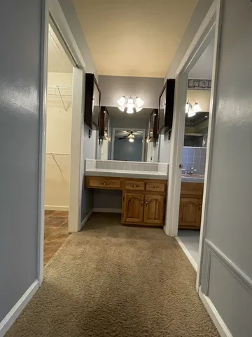 a view of a big room with kitchen cabinet and windows