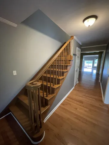 a view of entryway and hall with wooden floor