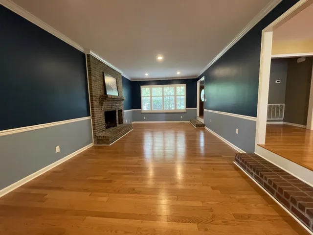 a view of a livingroom with an empty space and a window