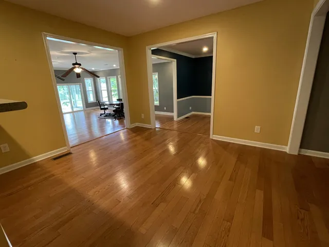 a view of a room with wooden floor