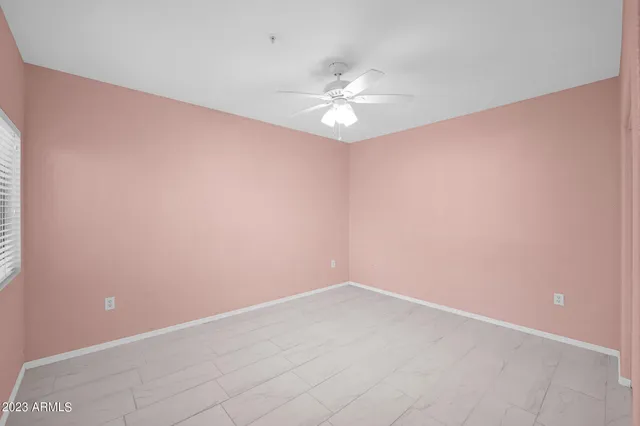 a bathroom with a granite countertop sink a toilet and a mirror