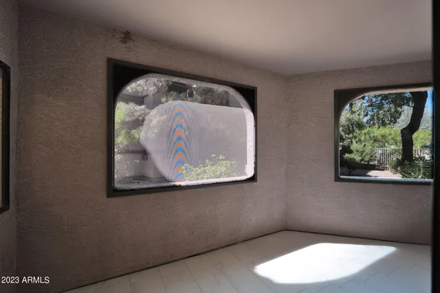 a patio with a table and chairs under an umbrella