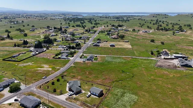 an aerial view of a residential houses with outdoor space