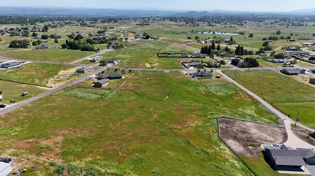an aerial view of a houses with a yard