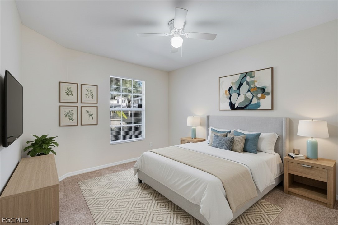 5304 Glenlivet Road Fort Myers, FL 33907 - Photo 11 of 19 a bedroom with a large bed and a chandelier