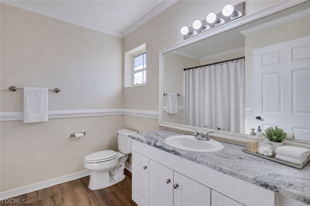 5304 Glenlivet Road Fort Myers, FL 33907 - Photo 13 of 19 a bathroom with a granite countertop sink a toilet and a mirror