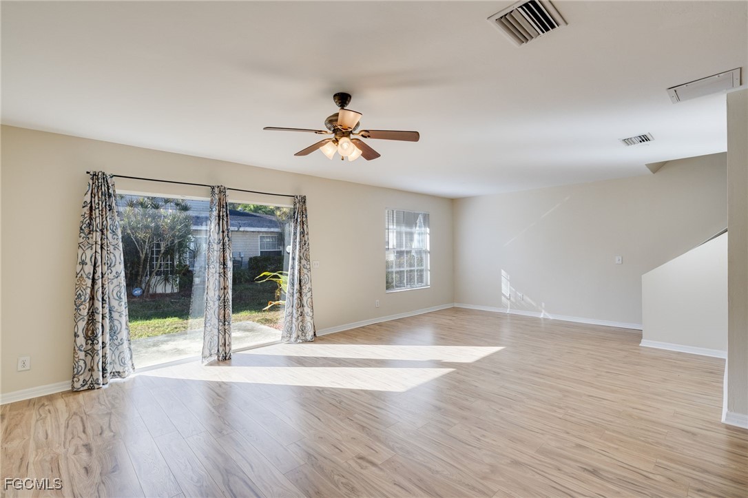 5304 Glenlivet Road Fort Myers, FL 33907 - Photo 5 of 19 a view of an empty room with a window and wooden floor