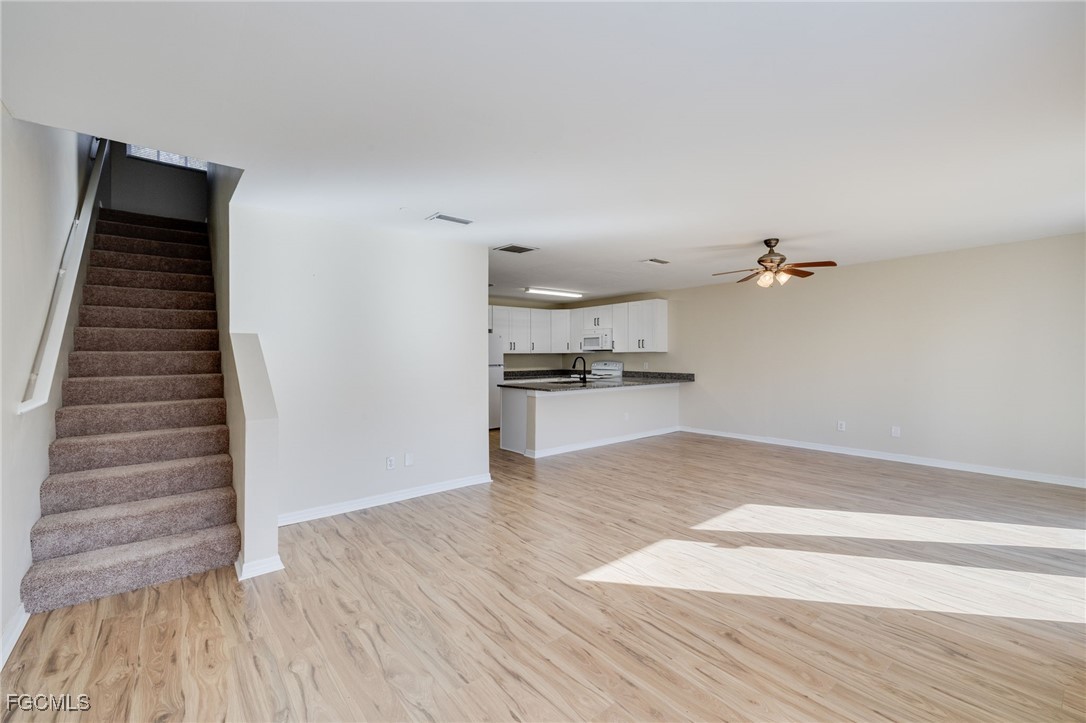 5304 Glenlivet Road Fort Myers, FL 33907 - Photo 6 of 19 a view of kitchen and hallway with wooden floor