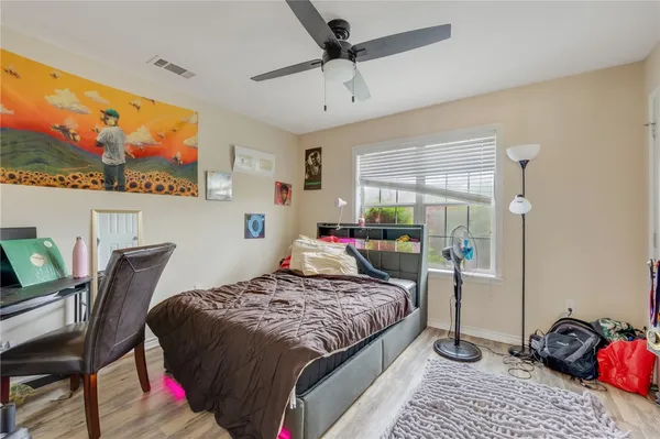 a bedroom with a bed window and a flat screen tv