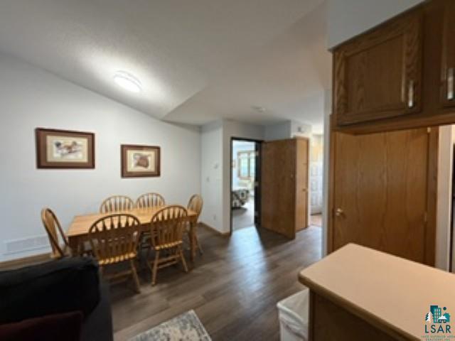 6266 Giants Ridge Road Biwabik, MN 55705 - Photo 8 of 30 Vaulted ceiling, wood-finish flooring, wood cabinetry, built-in overhead lighting, and interior wood doors