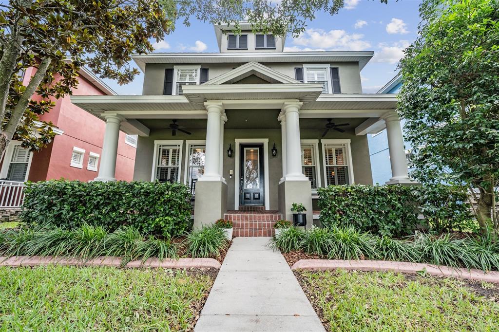 front view of a brick house with a yard