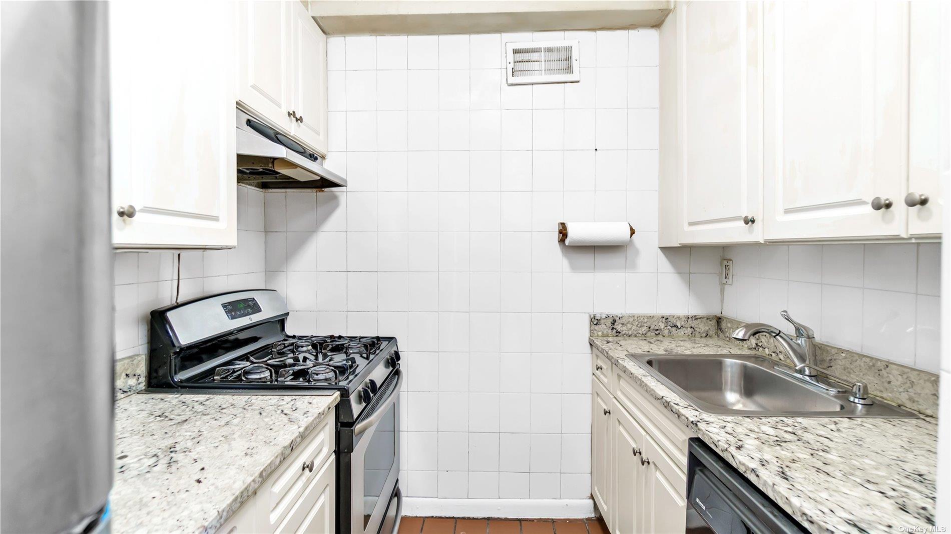 2400 Johnson Avenue, Unit 1B Bronx, NY 10463 - Photo 11 of 29 a kitchen with granite countertop a sink a stove and cabinets