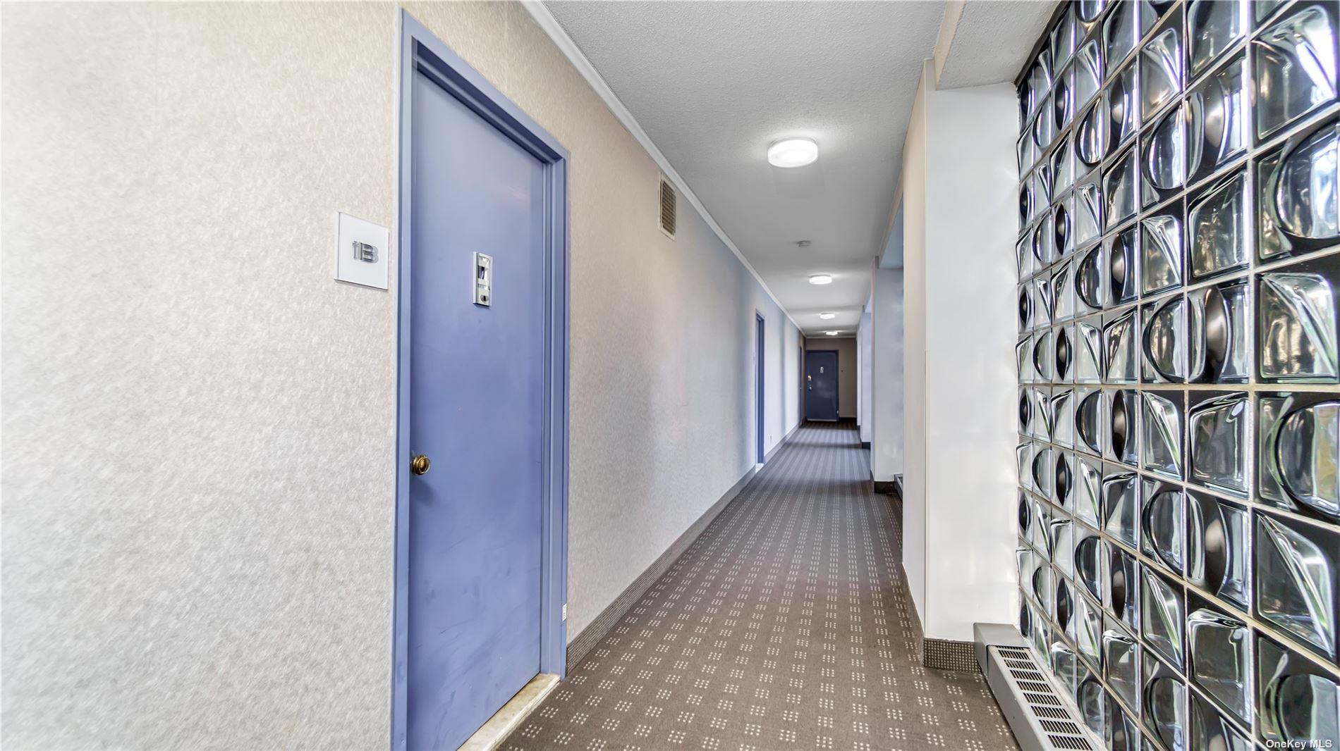 2400 Johnson Avenue, Unit 1B Bronx, NY 10463 - Photo 19 of 29 a view of hallway with a large window and a wooden floor