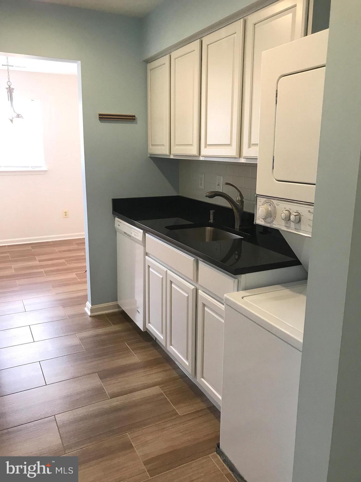 8591 Falls Run Road, Unit J Ellicott City, MD 21043 - Photo 5 of 16 Stacked W/D in kitchen