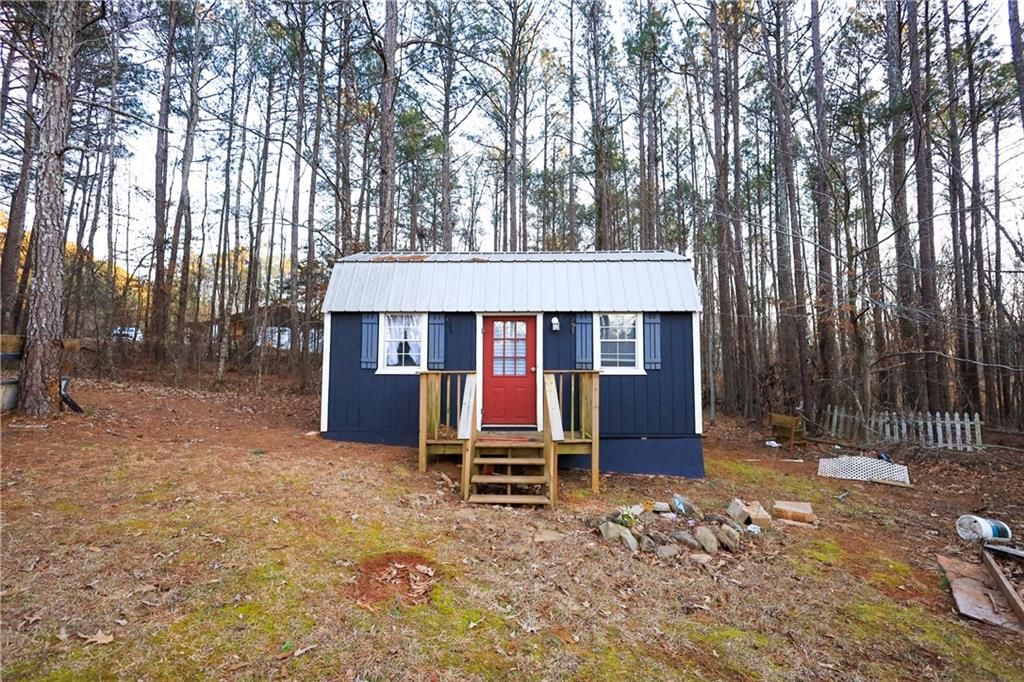 27 Hawks Trail Newborn, GA 30056 - Photo 18 of 29 a front view of a house with a yard covered in snow