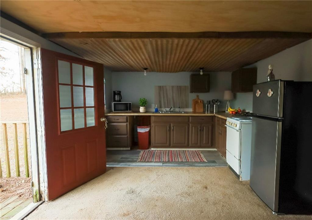 27 Hawks Trail Newborn, GA 30056 - Photo 19 of 29 a kitchen with stainless steel appliances granite countertop a refrigerator a sink a stove and a refrigerator