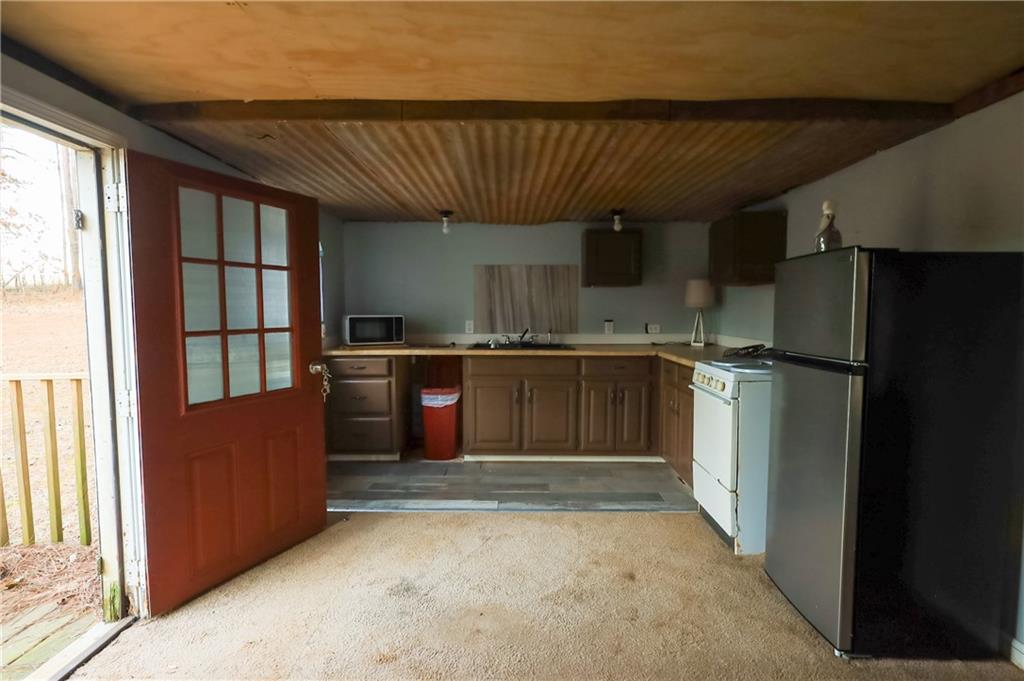 27 Hawks Trail Newborn, GA 30056 - Photo 20 of 29 a kitchen with stainless steel appliances granite countertop a refrigerator a sink and a stove