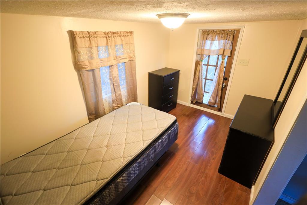 27 Hawks Trail Newborn, GA 30056 - Photo 22 of 29 a balcony with wooden floor and glass door