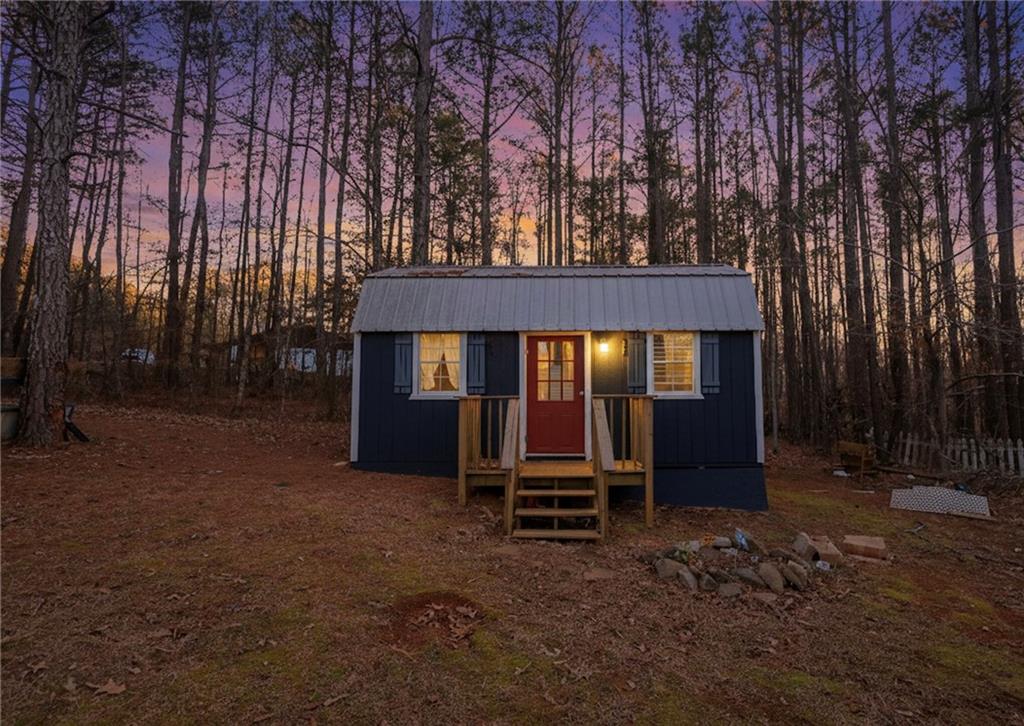 27 Hawks Trail Newborn, GA 30056 - Photo 7 of 29 a view of house with backyard and a large tree