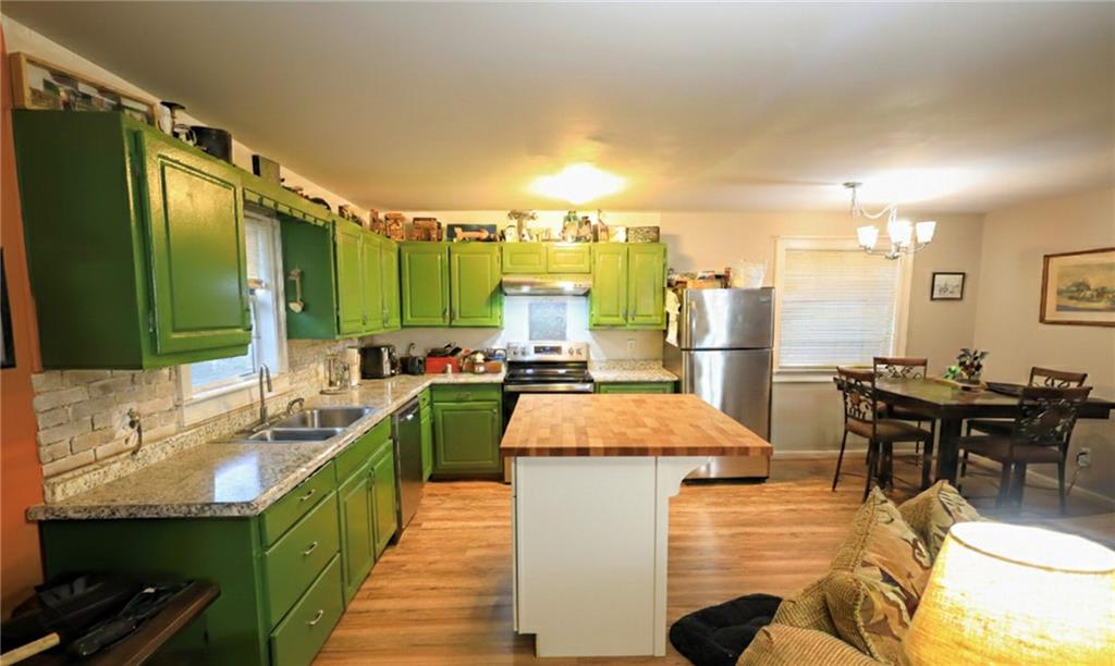 27 Hawks Trail Newborn, GA 30056 - Photo 9 of 29 a large kitchen that has a lot of cabinets a sink and a wooden floor