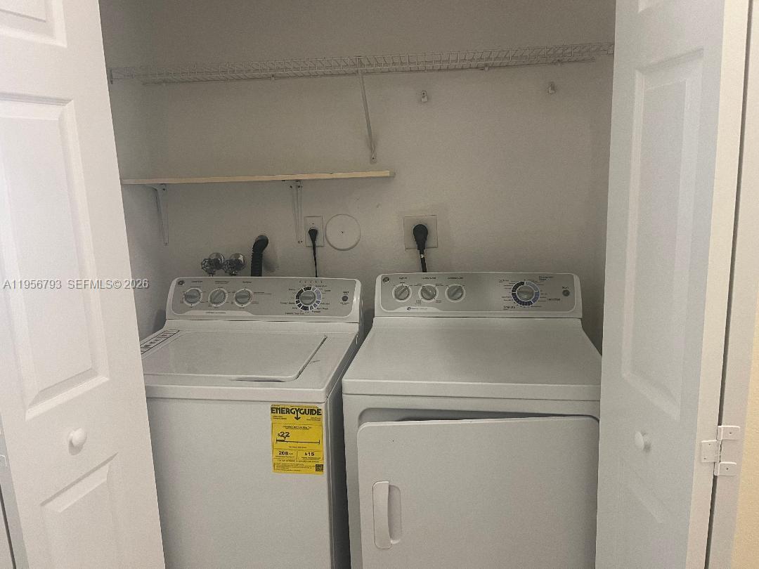11723 Southwest 137th Path, Unit 11723 Miami, FL 33186 - Photo 27 of 30 a utility room with dryer and washer