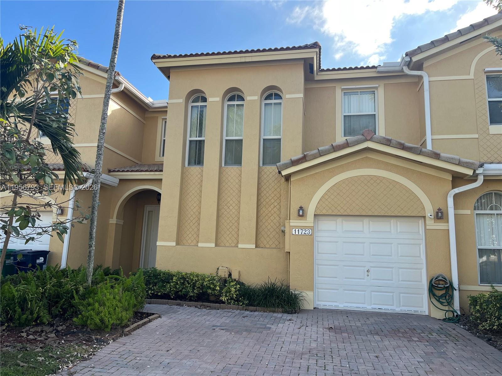 11723 Southwest 137th Path, Unit 11723 Miami, FL 33186 - Photo 30 of 30 a front view of a house with garden
