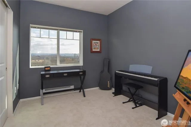 a view of a workspace with furniture and a window