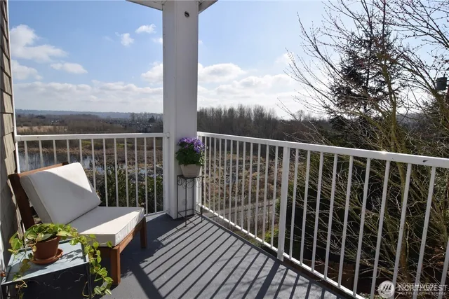 a view of balcony with wooden floor and seating space