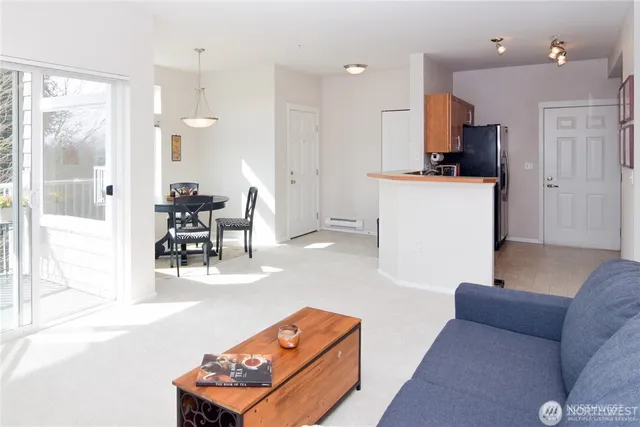 a living room with furniture and kitchen view