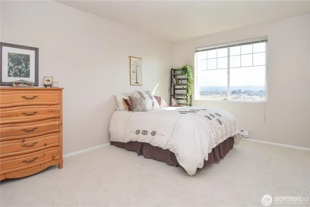 a bed sitting in a bedroom next to a window