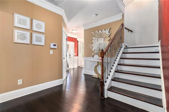a view of entryway with wooden floor and stairs