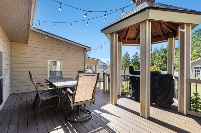 a patio with table and chairs and potted plants