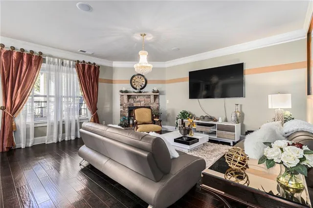 a living room with furniture a large window and a flat screen tv