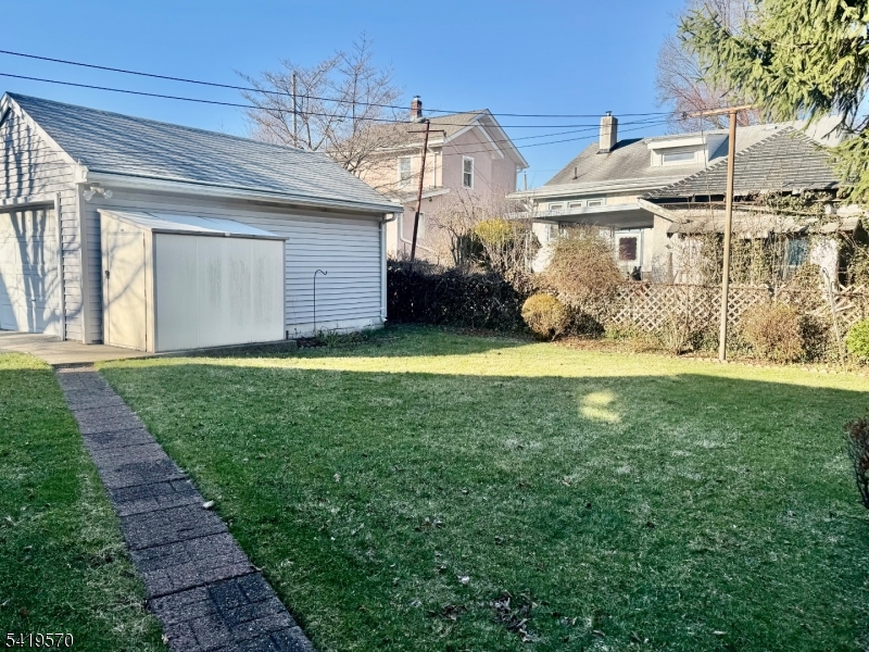 689 Linden Avenue Ridgefield, NJ 07657 - Photo 4 of 5 a view of a house with a yard and a garage
