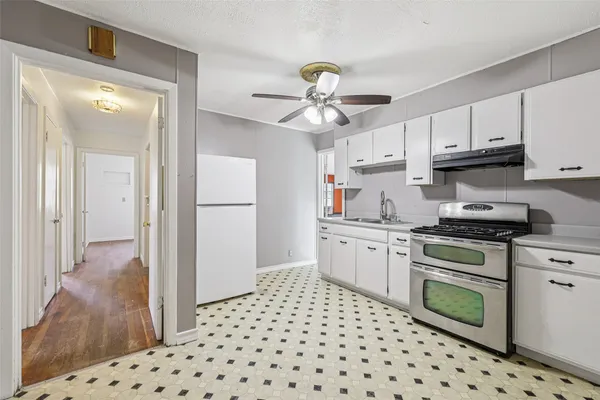a kitchen with granite countertop appliances a sink and a refrigerator