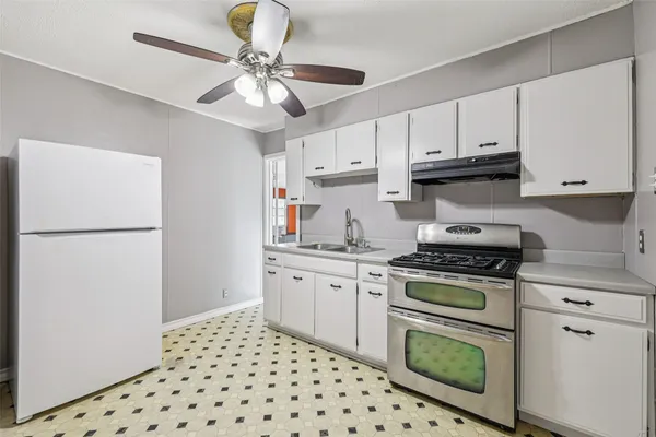 a kitchen with appliances cabinets and a sink