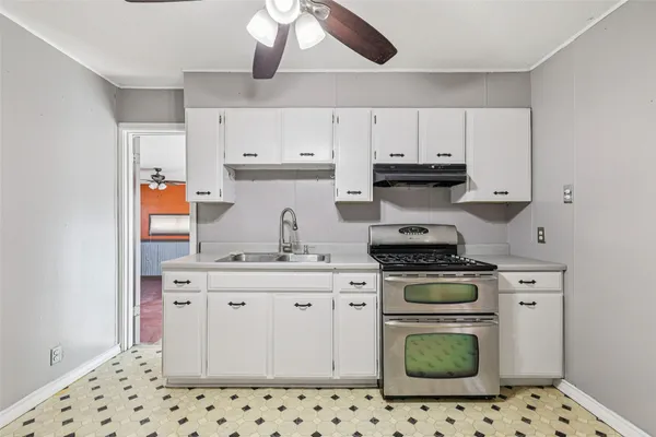 a kitchen with stainless steel appliances a stove a sink and a refrigerator