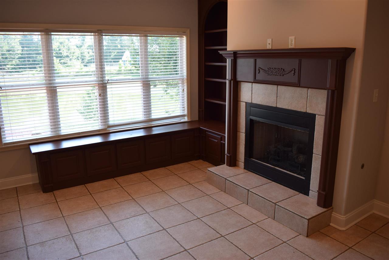 6546 Tracy Road Atoka, TN 38004 - Photo 13 of 24 a view of an empty room with a fireplace and a window