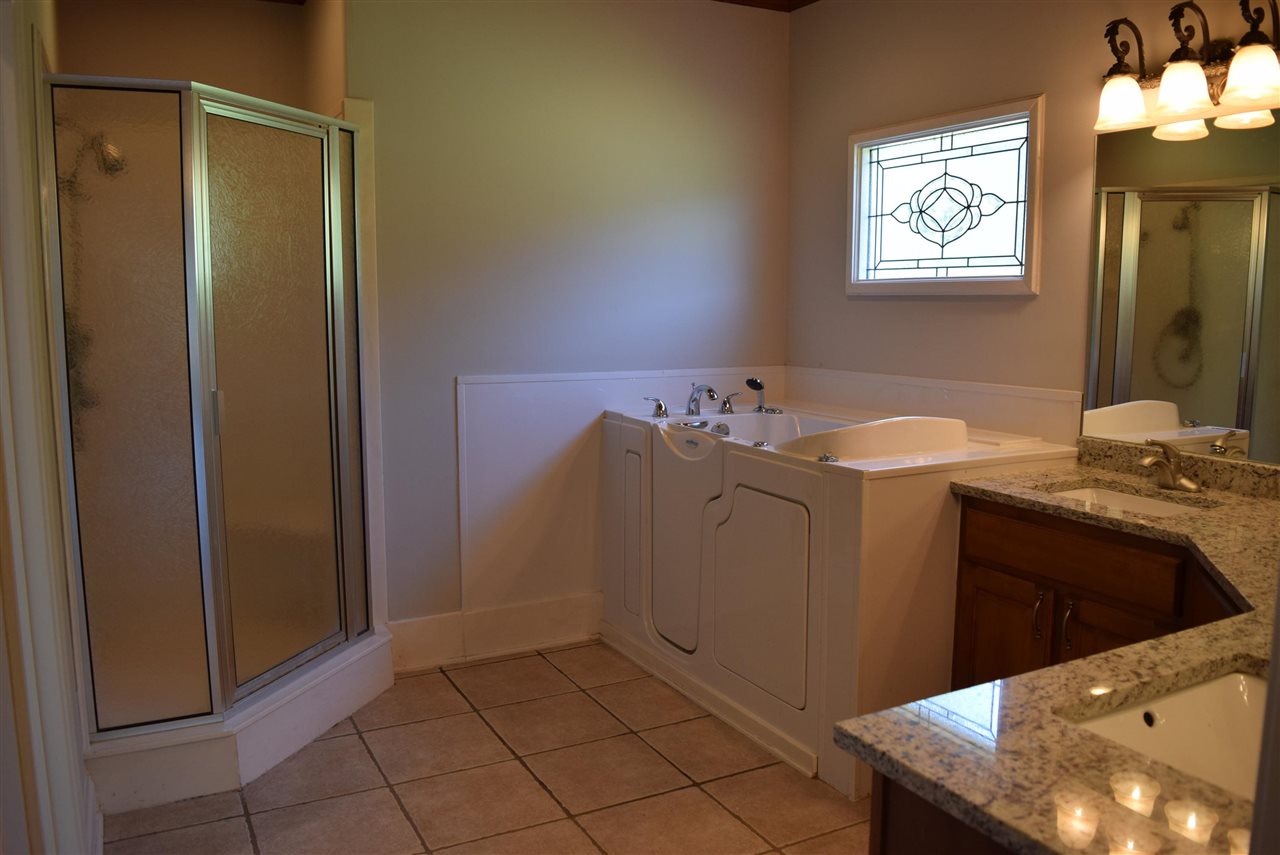 6546 Tracy Road Atoka, TN 38004 - Photo 15 of 24 a bathroom with a sink a vanity and a mirror