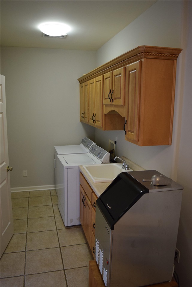 6546 Tracy Road Atoka, TN 38004 - Photo 21 of 24 a utility room with a sink a washer and dryer