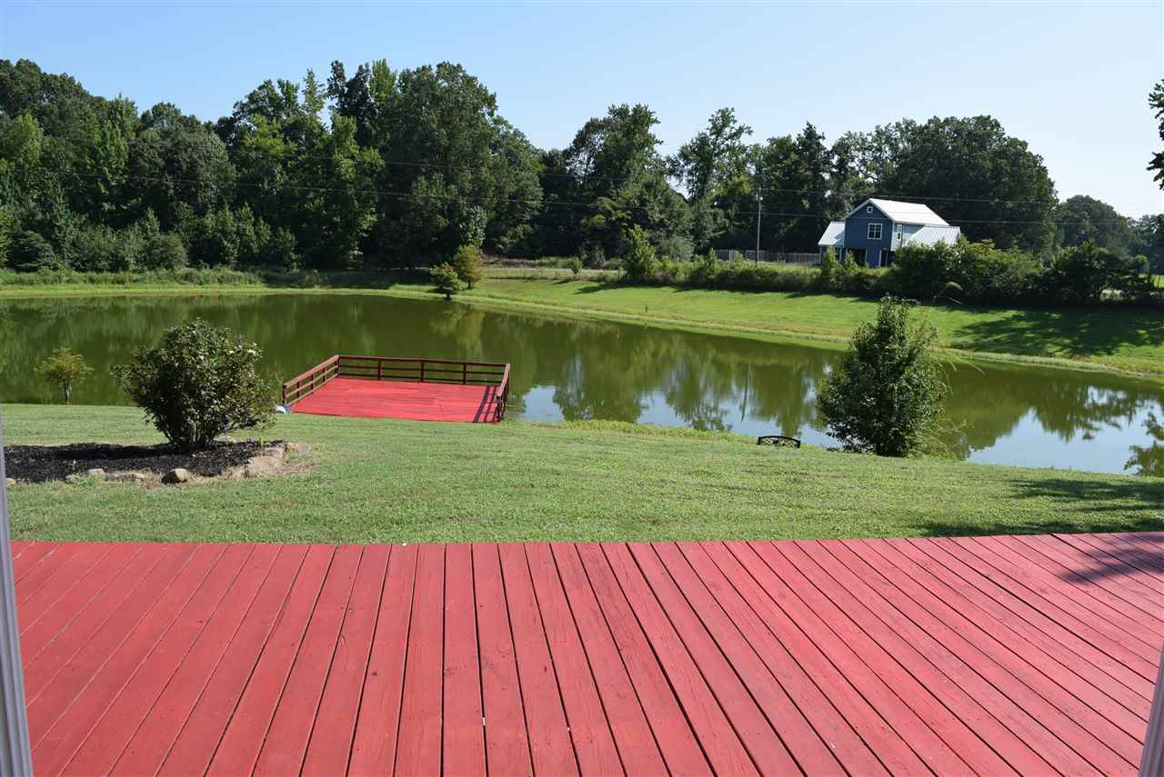 6546 Tracy Road Atoka, TN 38004 - Photo 5 of 24 a view of a park with large trees and a wooden fence