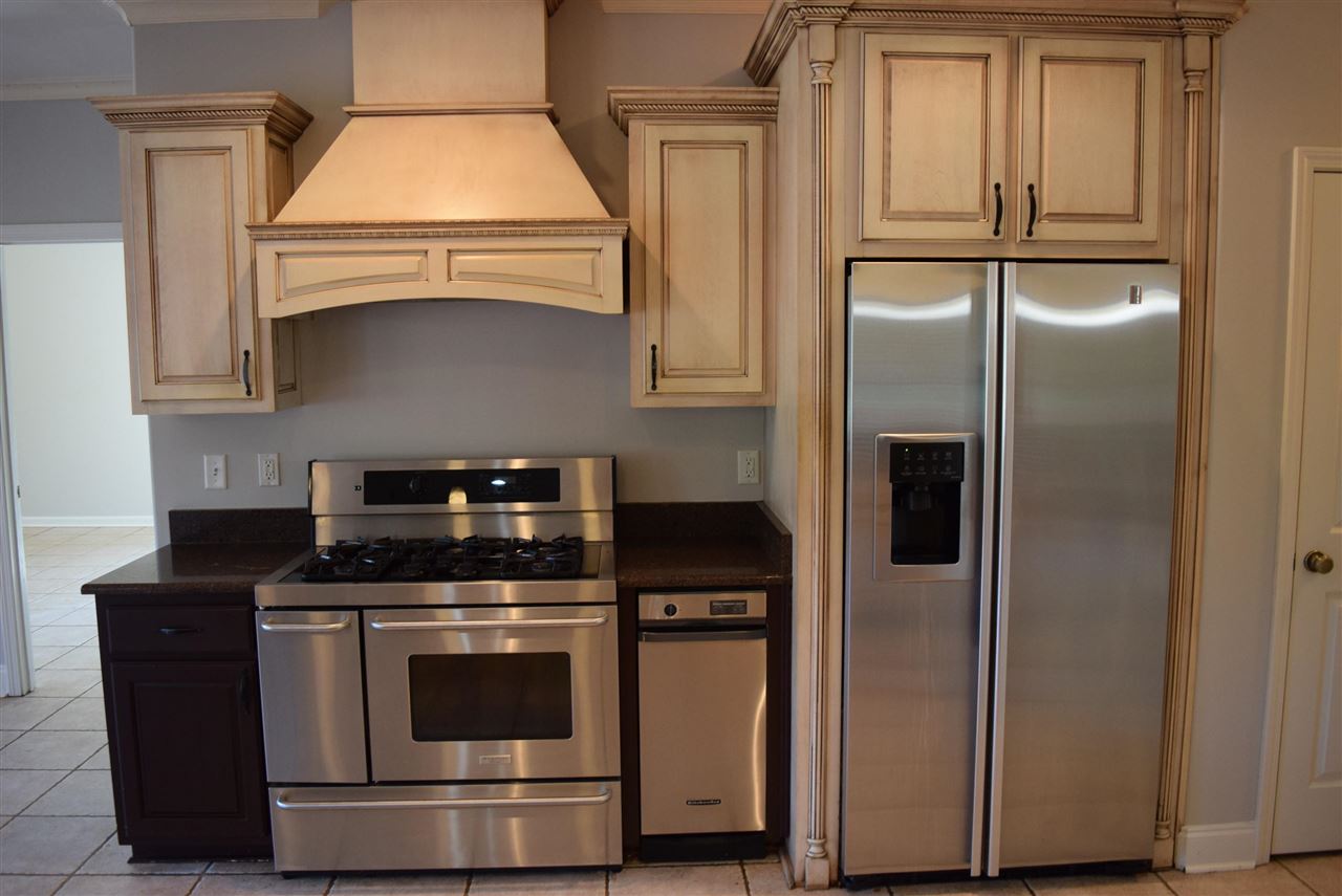 6546 Tracy Road Atoka, TN 38004 - Photo 9 of 24 a kitchen with stainless steel appliances granite countertop white cabinets and a granite counter tops