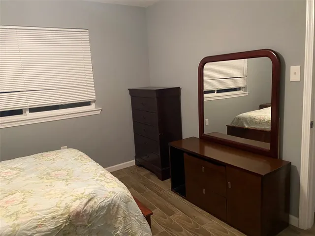 a bedroom with a bed and mirror