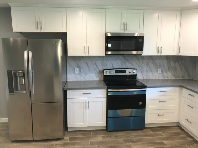 a kitchen with a stove and a refrigerator