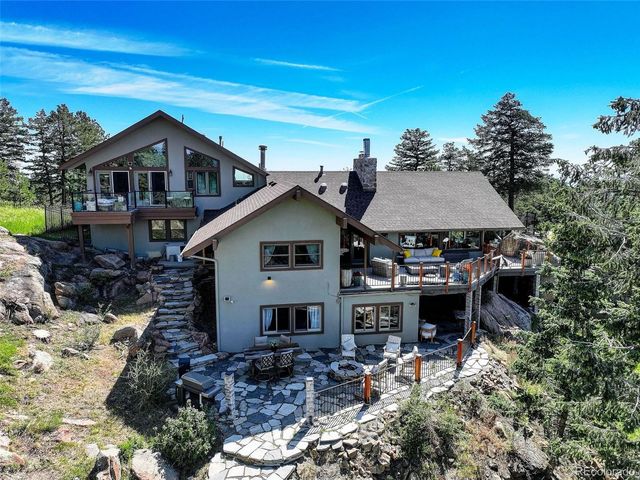 a view of a balcony with chairs and a potted plant