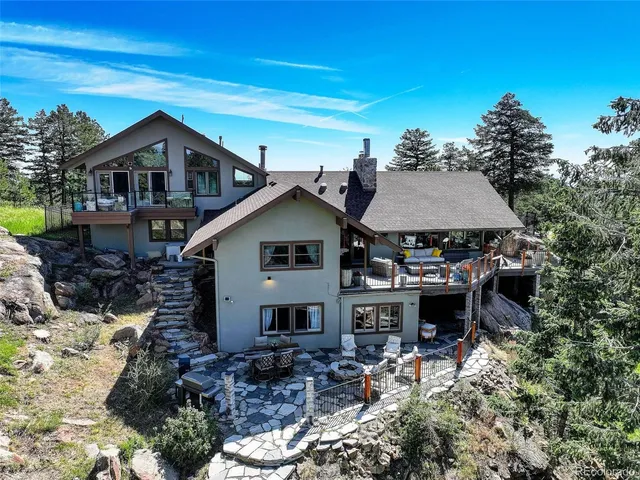 a view of a balcony with chairs and a potted plant
