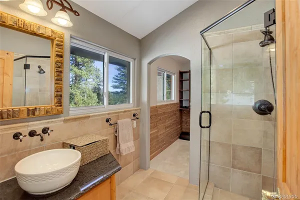 a spacious bathroom with a bathtub and a shower