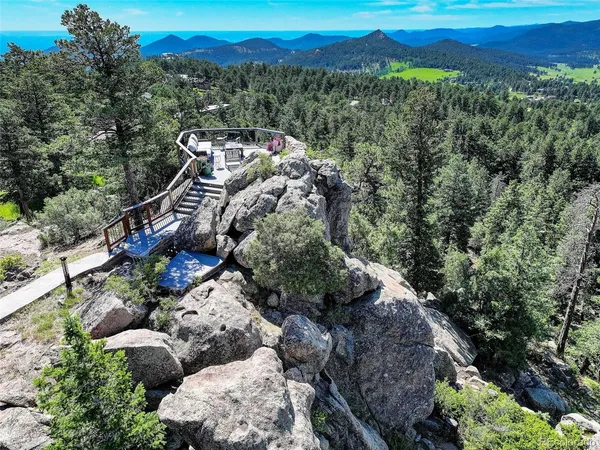 a view of a chairs and table in the roof deck